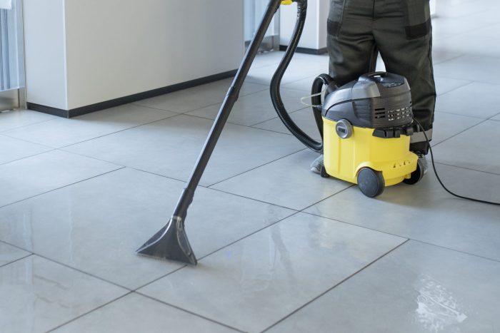 full-shot-man-vacuuming-office-floor